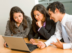 Team of workers on laptop