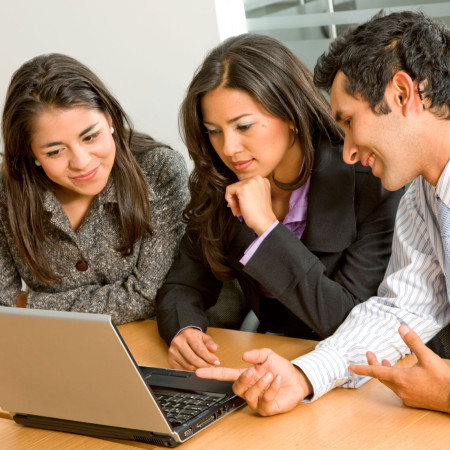 Team of workers on laptop